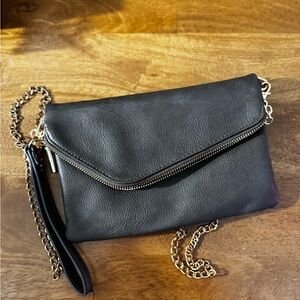 FashionPuzzle faux leather clutch bag with chain shoulder strap. Striped lining